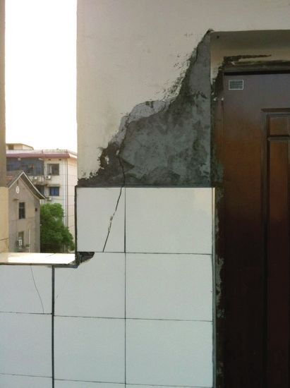5月28日，怀化市锦溪小学，教学楼之间走廊的一处墙壁出现裂缝，校方用水泥简单粉刷了一下。图/记者陈漫清 