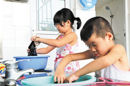 弟弟陈星宇和姐姐陈思思一起洗衣服。均为陈飞摄